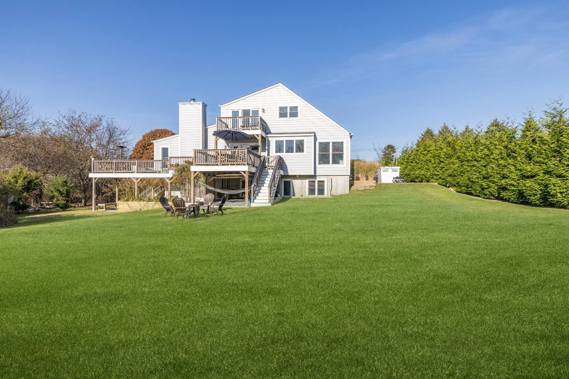 a front view of a house with a yard and trees