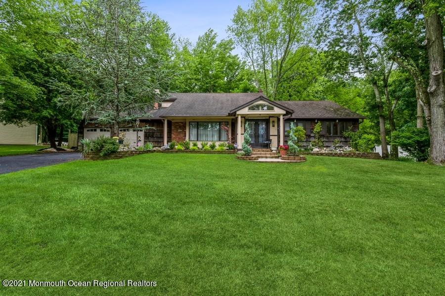 57 Millay Road Morganville, NJ 07751 - Photo 1 of 46 a front view of house with yard and green space