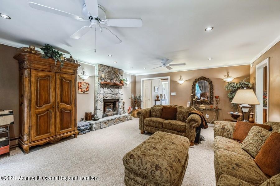 57 Millay Road Morganville, NJ 07751 - Photo 19 of 46 a living room with furniture and a fireplace