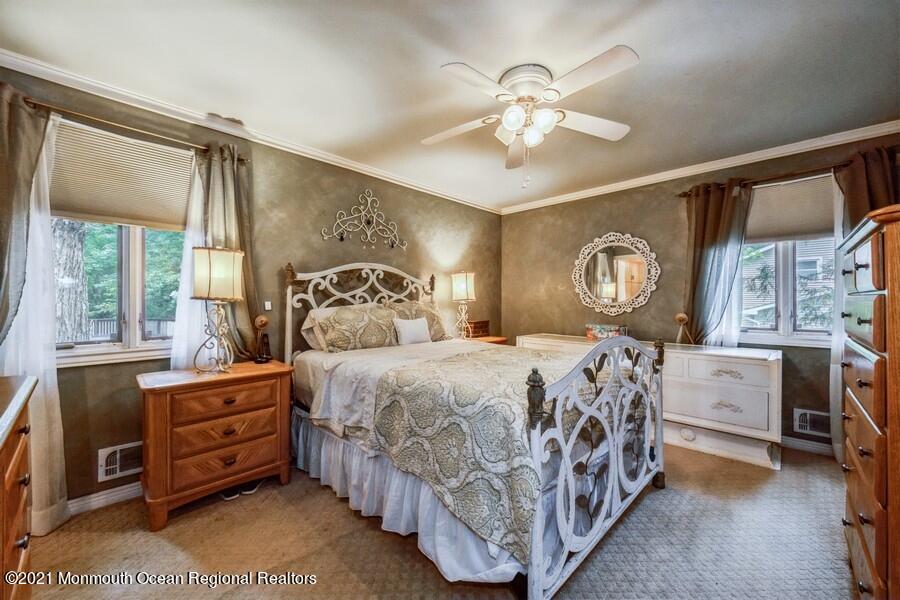 57 Millay Road Morganville, NJ 07751 - Photo 21 of 46 a bedroom with a bed and a chandelier