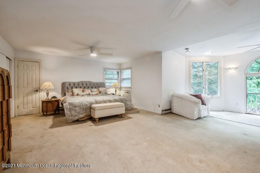 57 Millay Road Morganville, NJ 07751 - Photo 26 of 46 a spacious bedroom with a bed and a large window