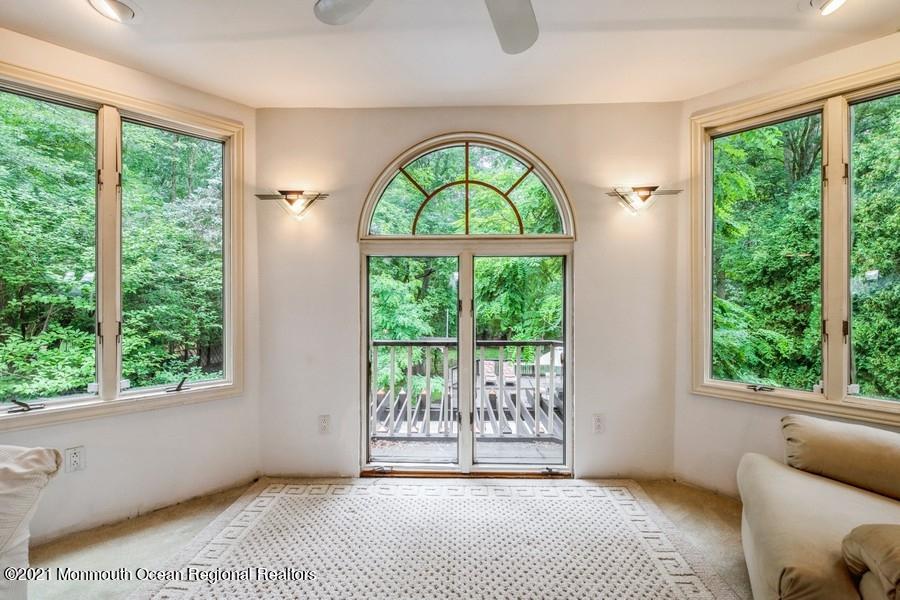 57 Millay Road Morganville, NJ 07751 - Photo 27 of 46 a view of an empty room with wooden floor and a window