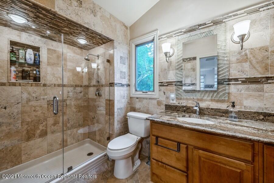 57 Millay Road Morganville, NJ 07751 - Photo 28 of 46 a bathroom with a granite countertop sink toilet and shower