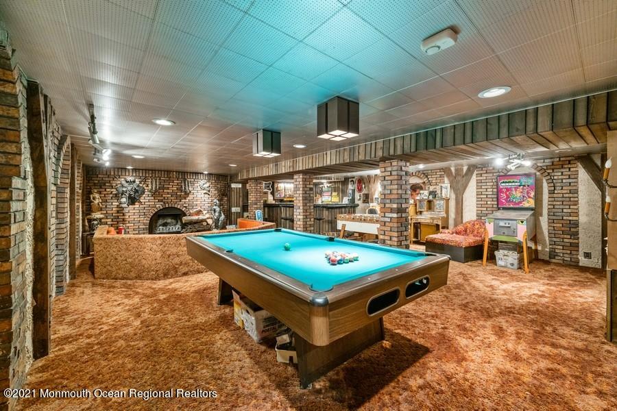 57 Millay Road Morganville, NJ 07751 - Photo 30 of 46 a living room with pool table and a flat screen tv