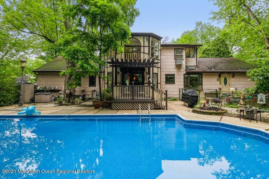 57 Millay Road Morganville, NJ 07751 - Photo 33 of 46 a front view of a house with swimming pool having outdoor seating