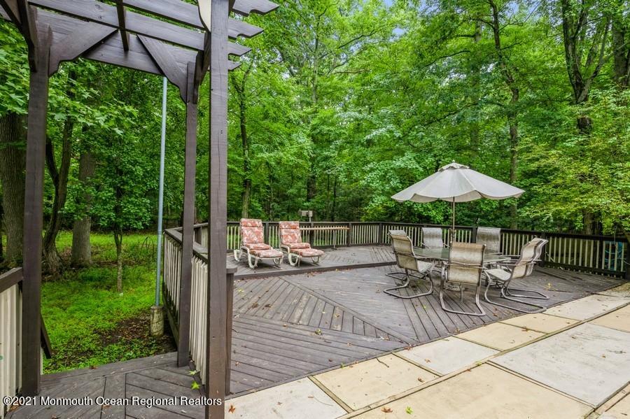 57 Millay Road Morganville, NJ 07751 - Photo 34 of 46 a patio with a yard table and chairs