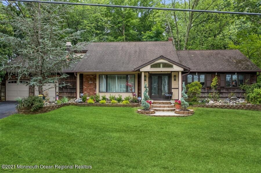 57 Millay Road Morganville, NJ 07751 - Photo 5 of 46 a front view of a house with a yard table and chairs