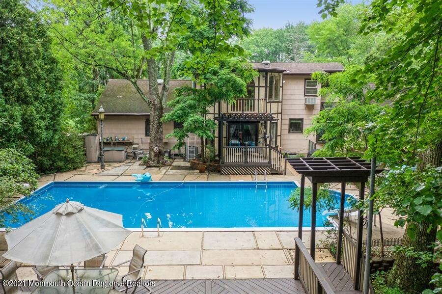 57 Millay Road Morganville, NJ 07751 - Photo 45 of 46 a view of house and outdoor space with swimming pool