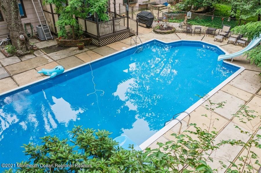 57 Millay Road Morganville, NJ 07751 - Photo 46 of 46 a view of a swimming pool with an outdoor seating