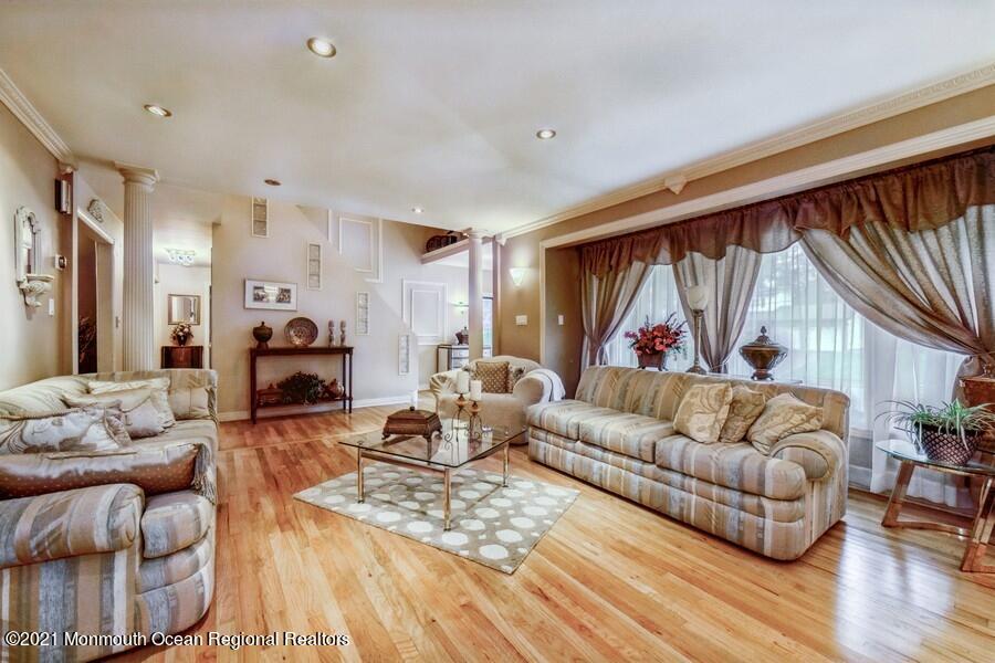 57 Millay Road Morganville, NJ 07751 - Photo 9 of 46 a living room with furniture a fireplace and a large window