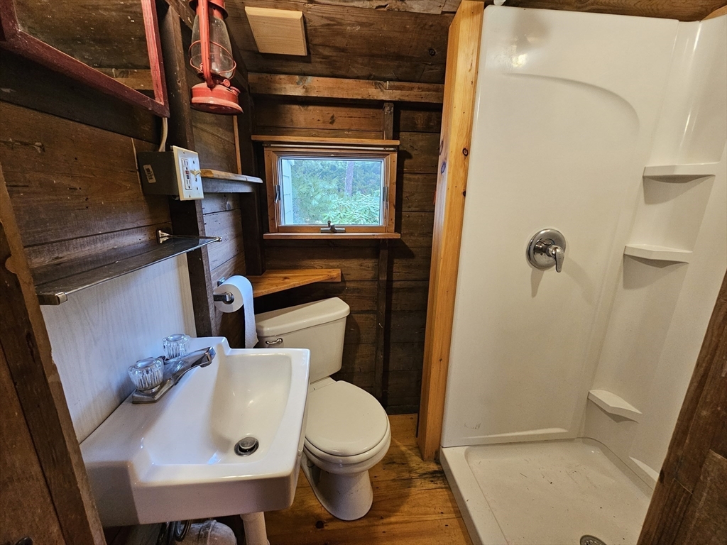 1937 State Hwy Route, Unit 8 Wellfleet, MA 02667 - Photo 15 of 17 a bathroom with a sink a toilet and shower
