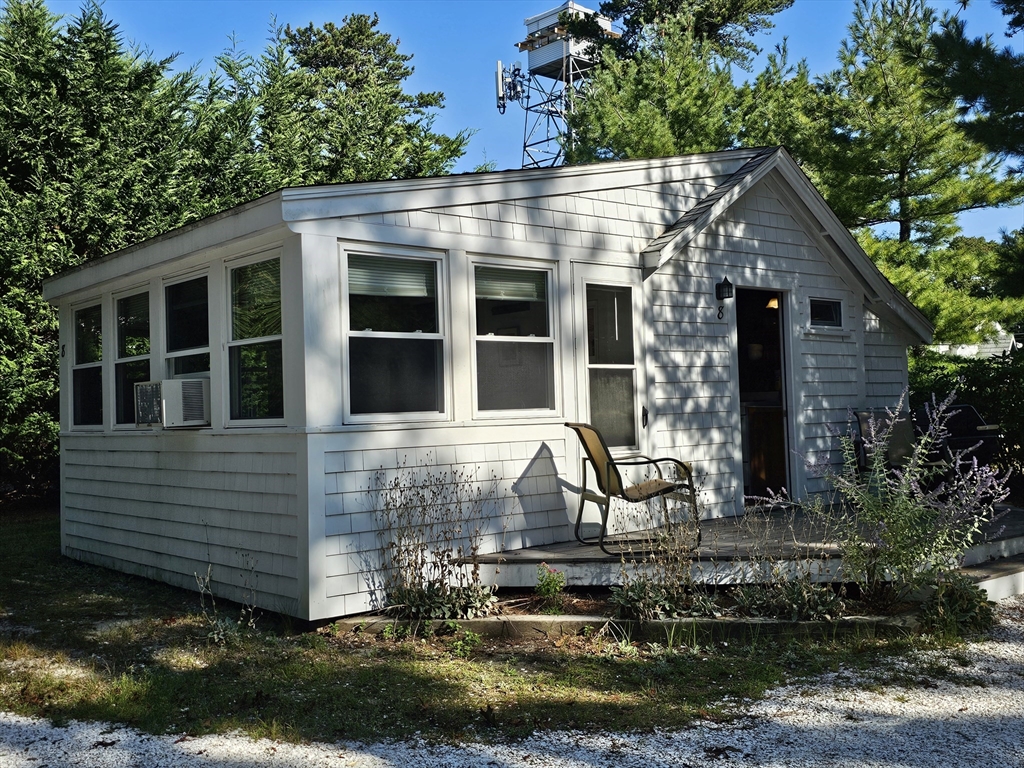 1937 State Hwy Route, Unit 8 Wellfleet, MA 02667 - Photo 3 of 17 a front view of a house with garden