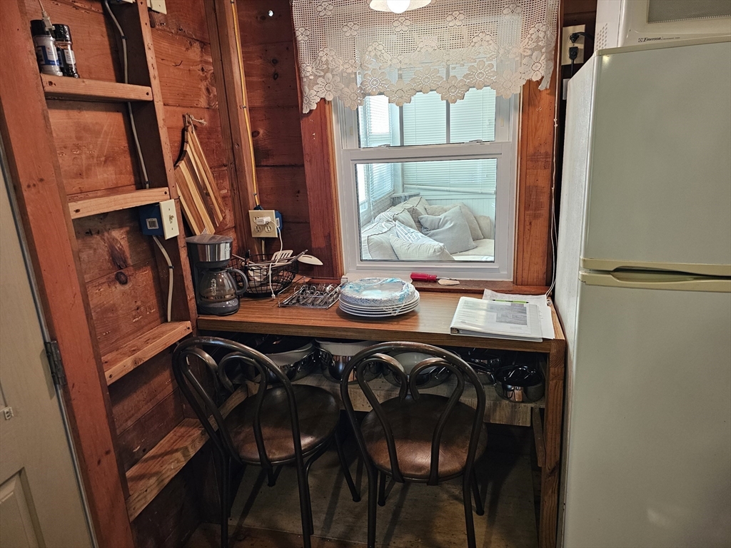 1937 State Hwy Route, Unit 8 Wellfleet, MA 02667 - Photo 9 of 17 a dining room with furniture and window