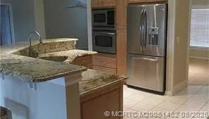 a kitchen with granite countertop a sink and a window