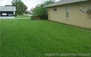 a view of a backyard with a garden and entertaining space