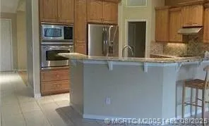 a kitchen with a refrigerator and cabinets