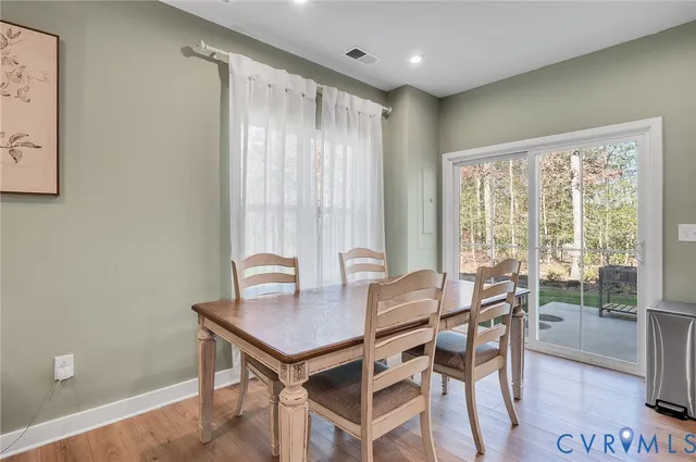 a view of a dining room with furniture and a window