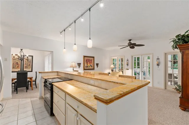 a kitchen with stainless steel appliances granite countertop a sink a stove and a refrigerator