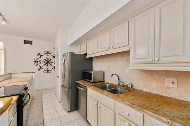 a bedroom with a bed chandelier and a window