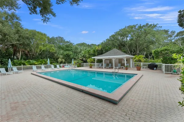 a view of a house with pool and a yard