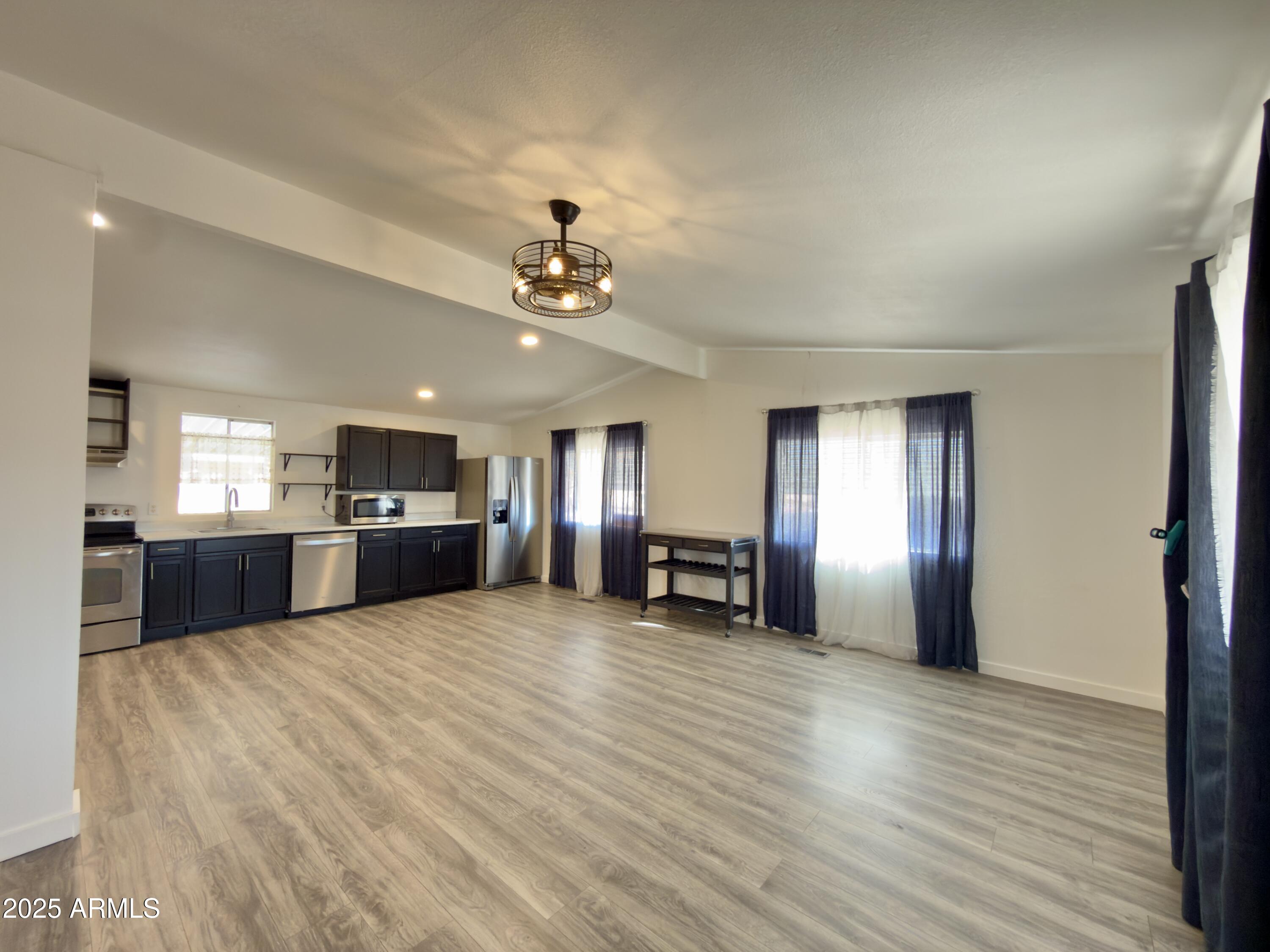 1855 West Southern Avenue, Unit 331 Apache Junction, AZ 85120 - Photo 3 of 13 a view of a hall with kitchen and sink