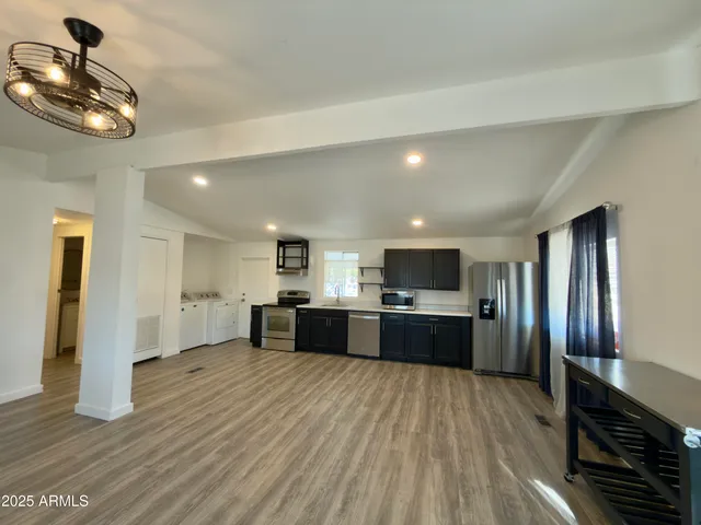 a large kitchen with a lot of counter space and stainless steel appliances