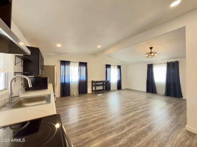 a view of a kitchen with a sink dishwasher refrigerator and stove