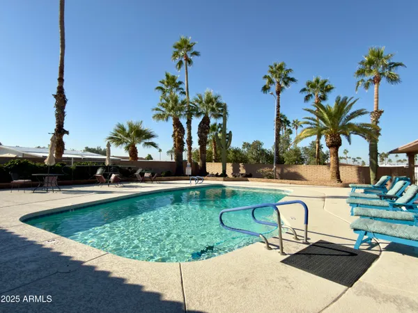 a view of swimming pool with seating space