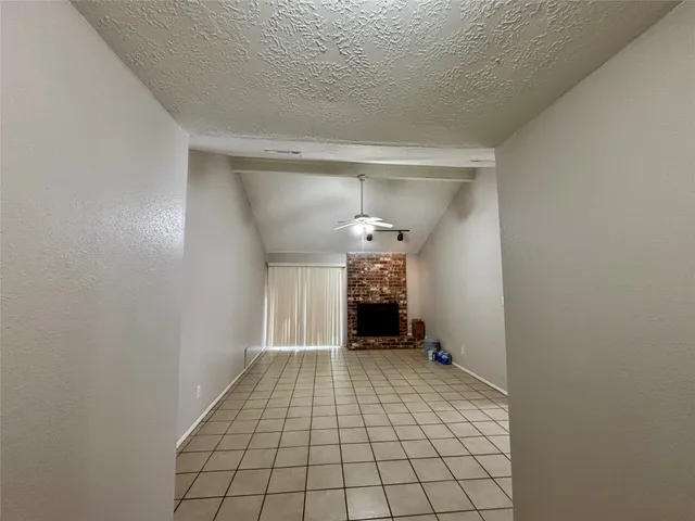 a view of an empty room and fire place