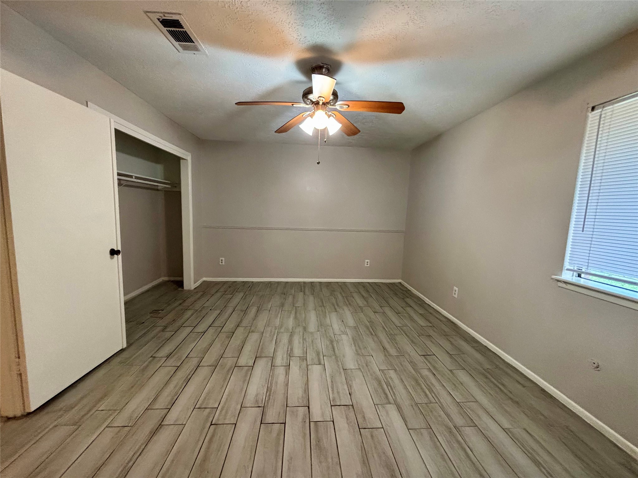 4426 Hirschfield Road Spring, TX 77373 - Photo 3 of 20 wooden floor in an empty room with a window