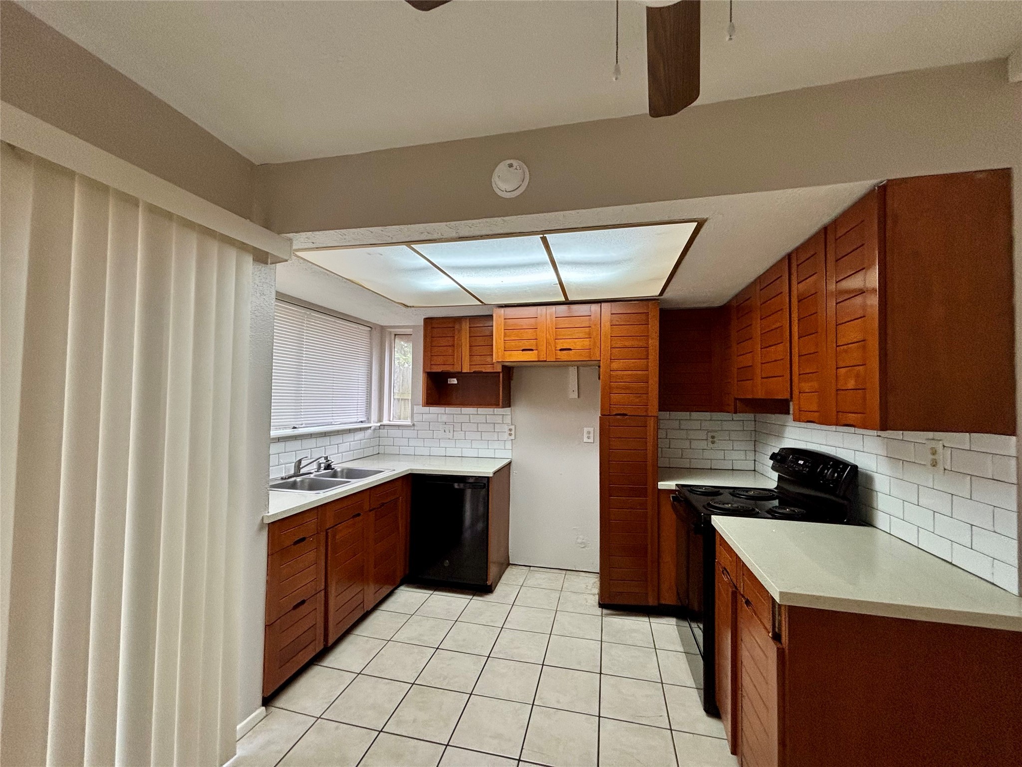 4426 Hirschfield Road Spring, TX 77373 - Photo 7 of 20 a kitchen with a sink a stove top oven and cabinets