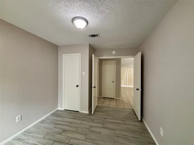 a view of hallway with wooden floor
