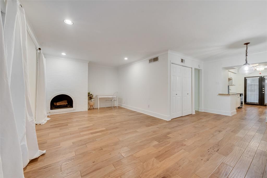 7732 Meadow Road, Unit 110 Dallas, TX 75230 - Photo 1 of 19 Wood burning fireplace, open living room