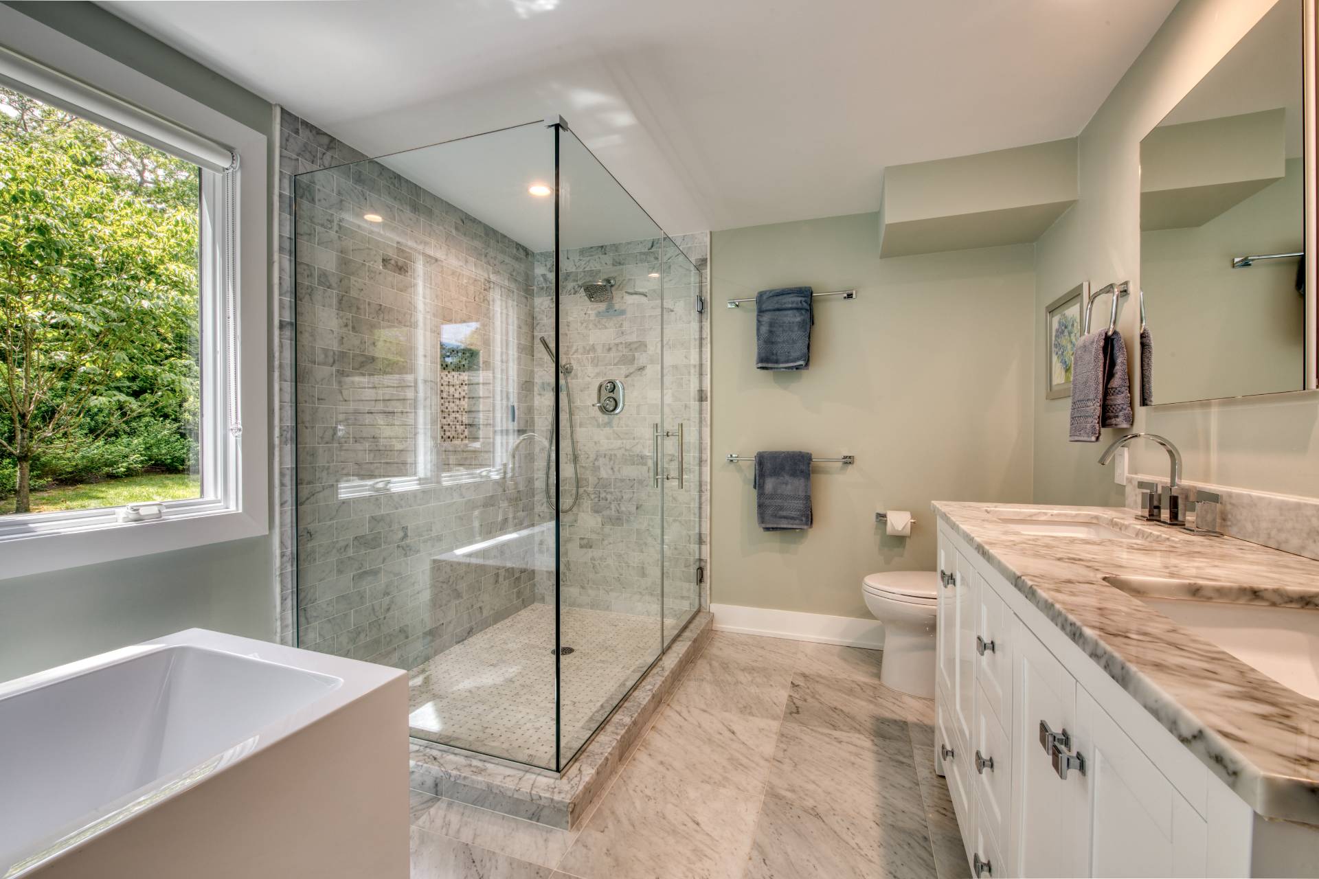 30 Springwood Way East Hampton, NY 11937 - Photo 13 of 32 a bathroom with a granite countertop sink a toilet a large mirror and shower