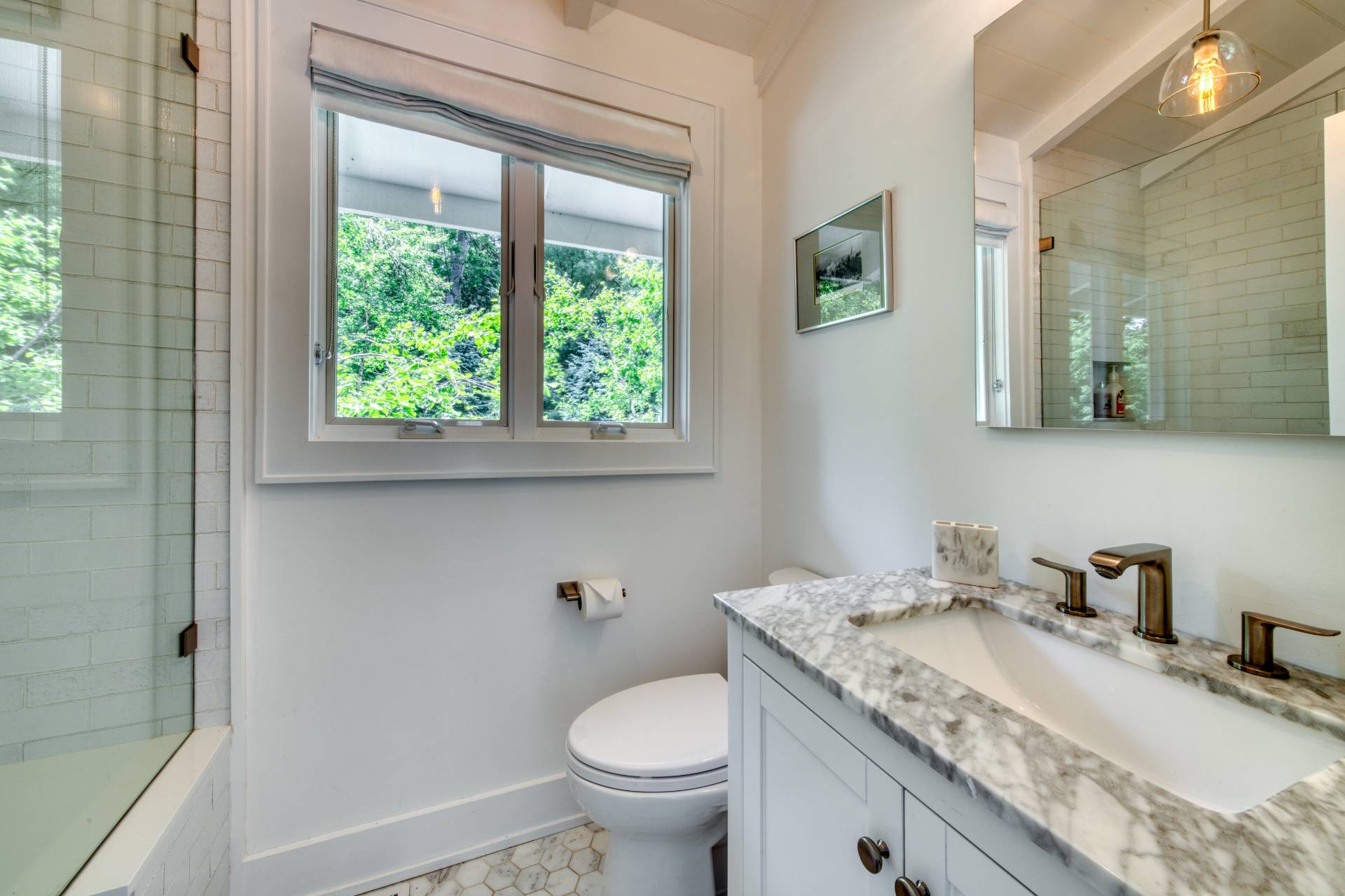 30 Springwood Way East Hampton, NY 11937 - Photo 19 of 32 a bathroom with a granite countertop toilet a sink and a mirror