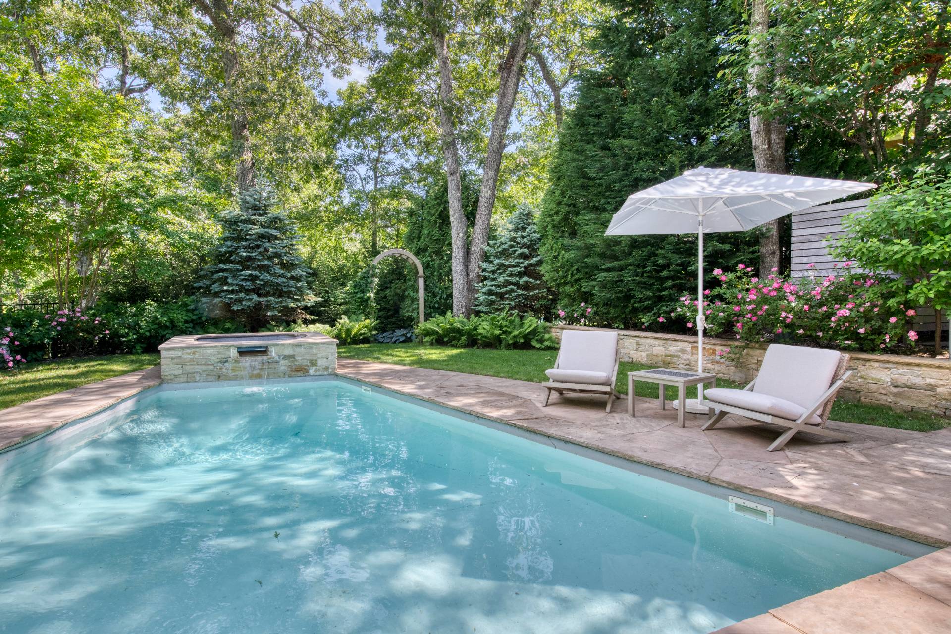 30 Springwood Way East Hampton, NY 11937 - Photo 28 of 32 an outdoor sitting area with a bench and trees