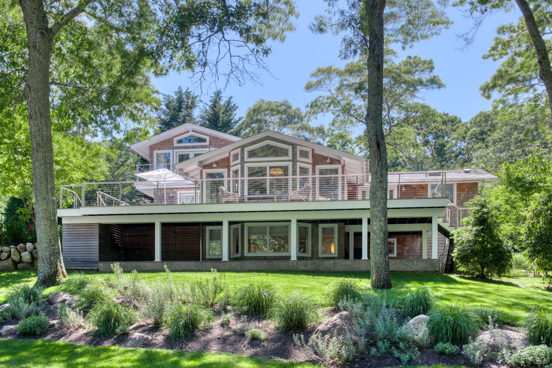 30 Springwood Way East Hampton, NY 11937 - Photo 5 of 32 a front view of a house with a garden