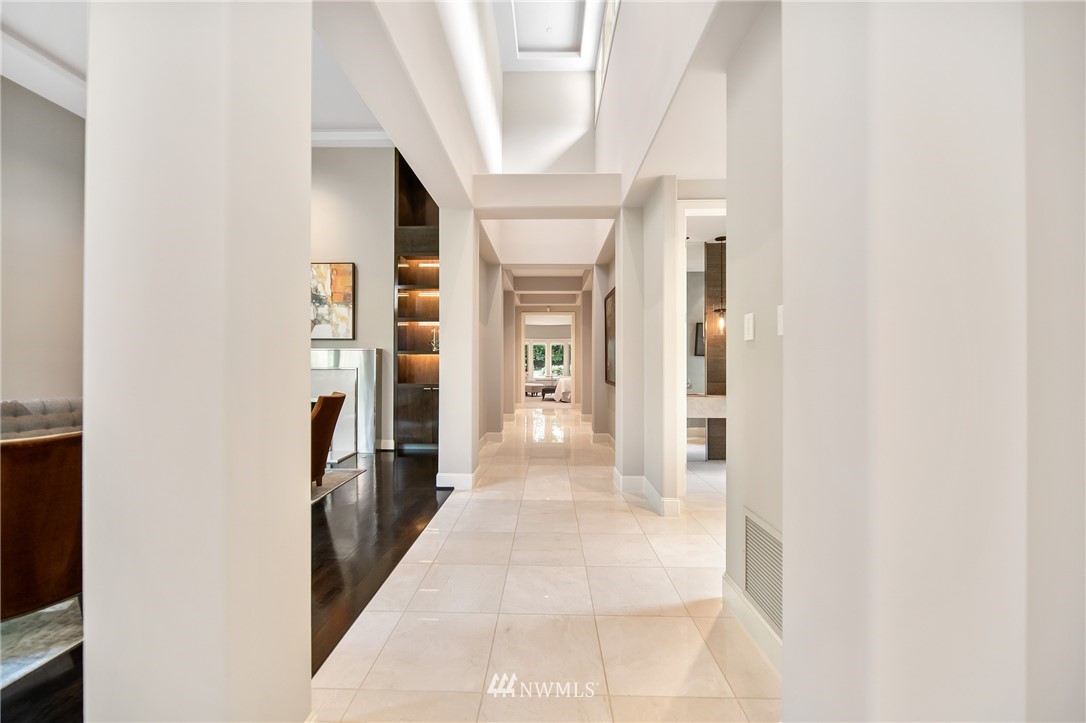 26630 Southeast Issaquah-Fall City Road Issaquah, WA 98029 - Photo 12 of 40 a hallway with white doors wooden floor and stairs