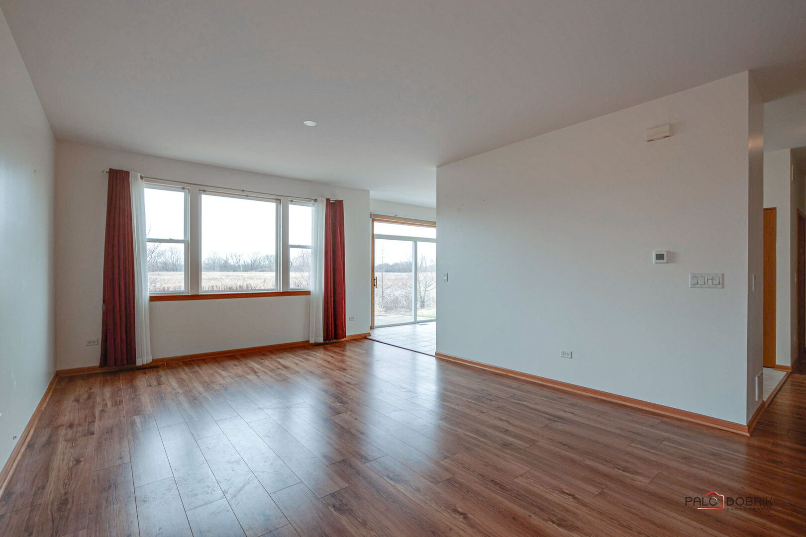 269 Enfield Lane Grayslake, IL 60030 - Photo 8 of 45 a view of an empty room with wooden floor and a window