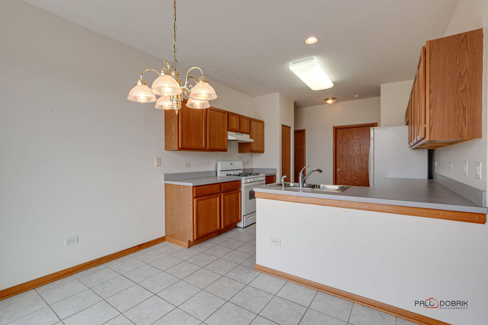 269 Enfield Lane Grayslake, IL 60030 - Photo 10 of 45 a kitchen with stainless steel appliances granite countertop a sink a stove top oven a counter space and cabinets