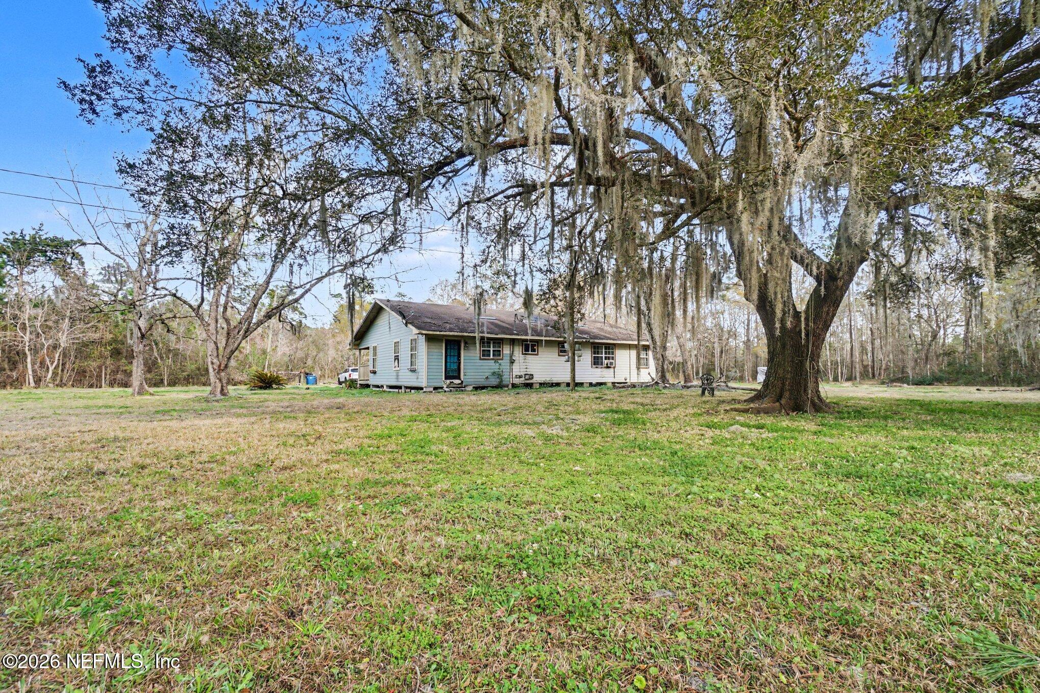 3390 Lannie Road Jacksonville, FL 32218 - Photo 16 of 18 a view of a house with a yard
