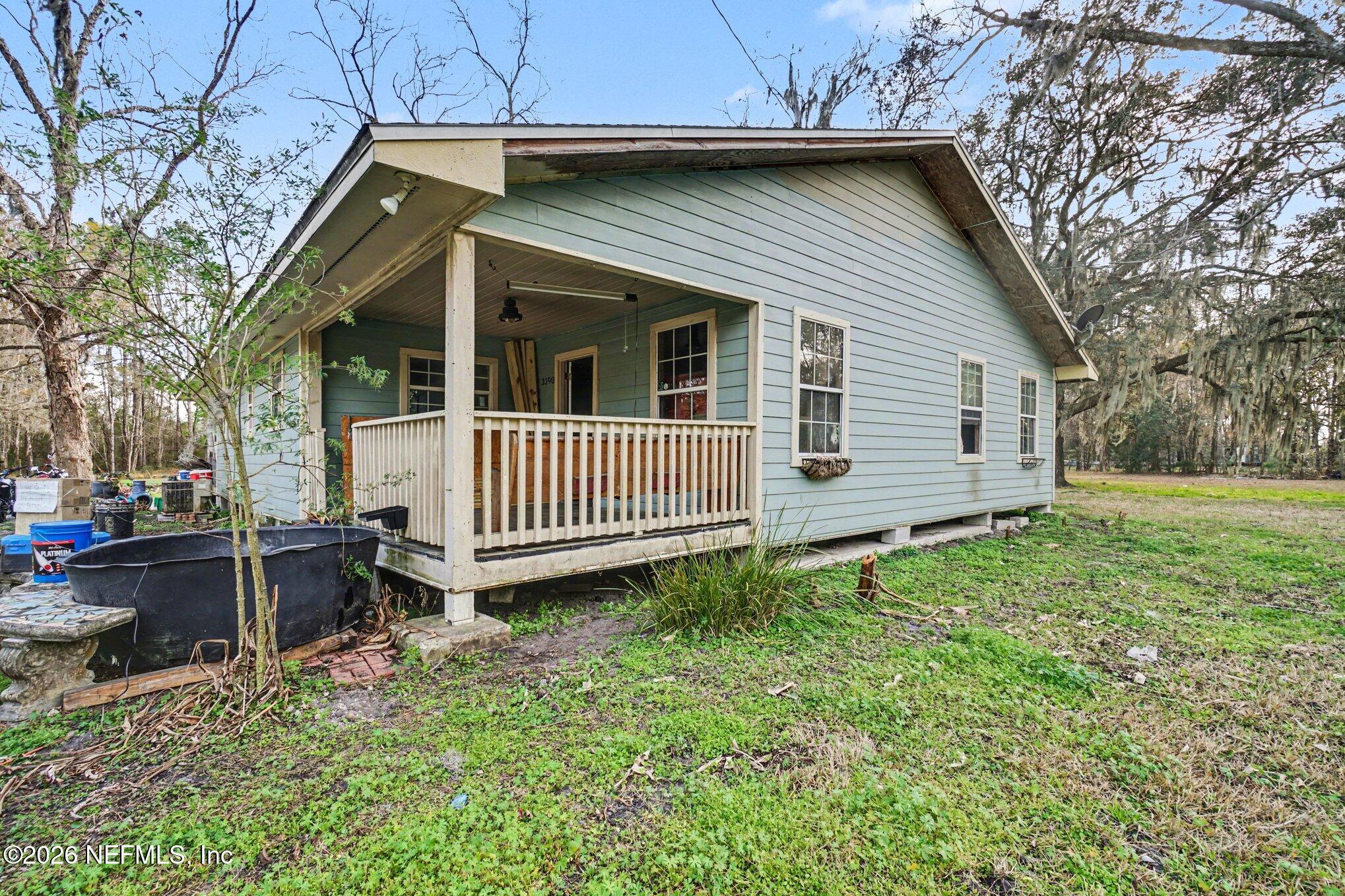 3390 Lannie Road Jacksonville, FL 32218 - Photo 18 of 18 a view of a house with a yard