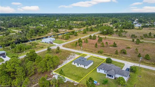 an aerial view of residential houses with outdoor space and river