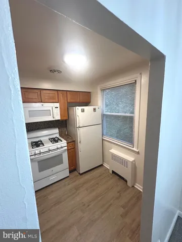 a kitchen with a stove a sink and a refrigerator