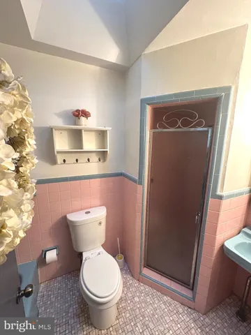 a bathroom with a toilet and a tub