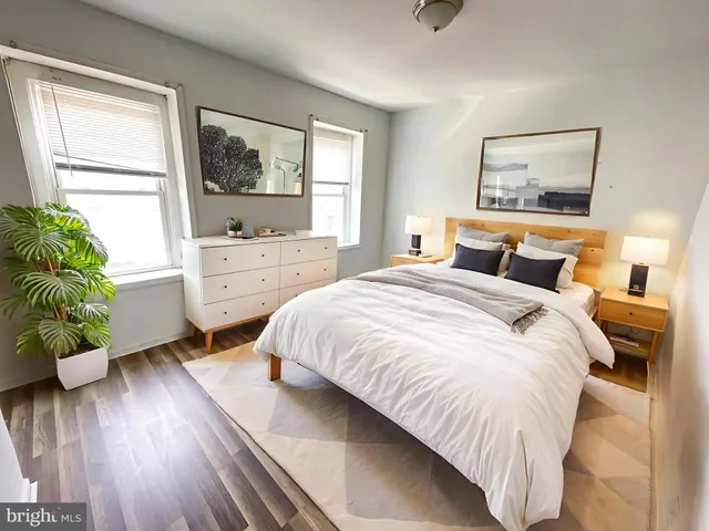 a bedroom with a large bed and a large window