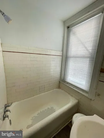 a bath tub sitting next to a window