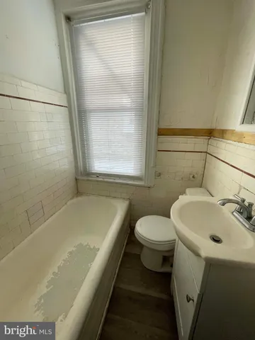 a bath room with a sink and a toilet