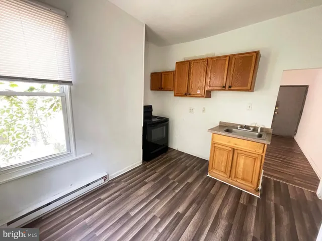 a view of a refrigerator in kitchen and wooden floor