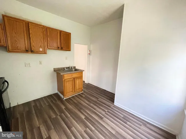 a room with wooden floor and utility